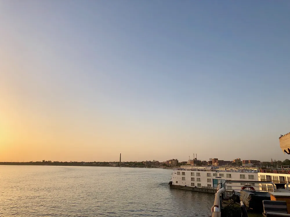 A Nile cruise ship moored at sunset near Kom Ombo