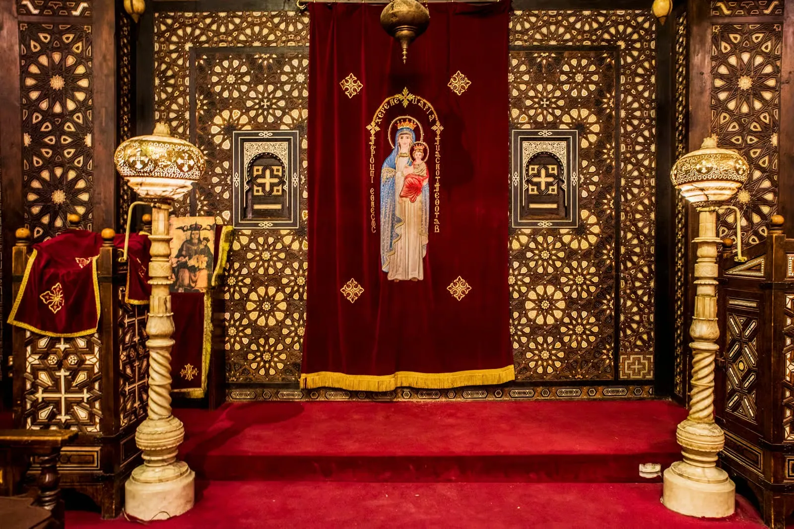 A carved icon screen with an icon of the Virgin Mary