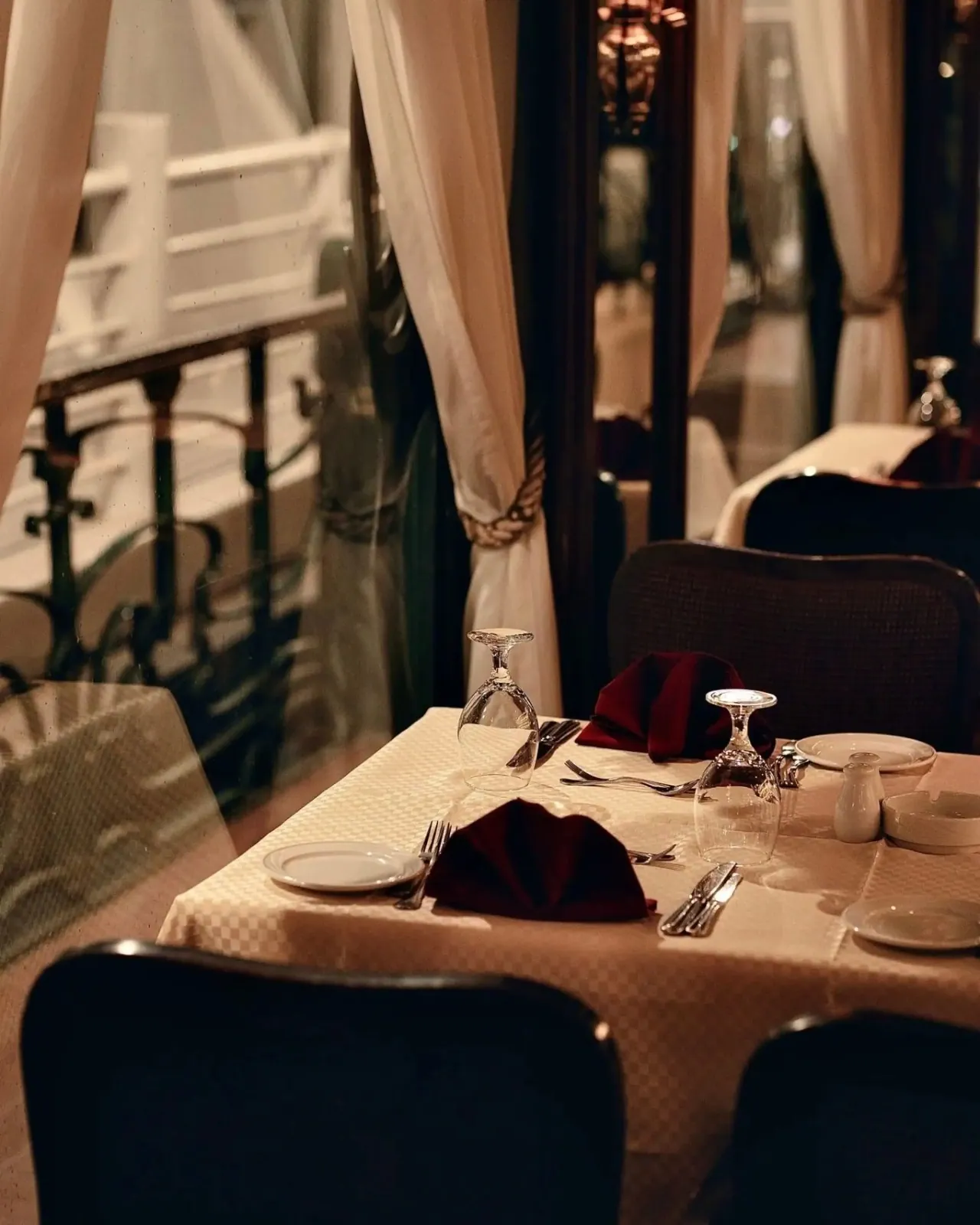 A set dinner table on deck at night