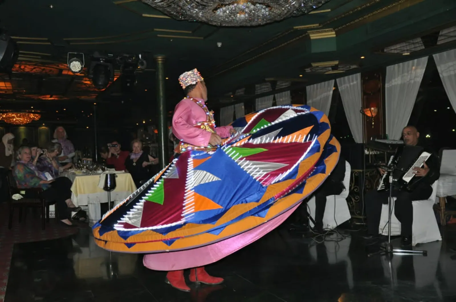 A Tanoura dancer with a live band