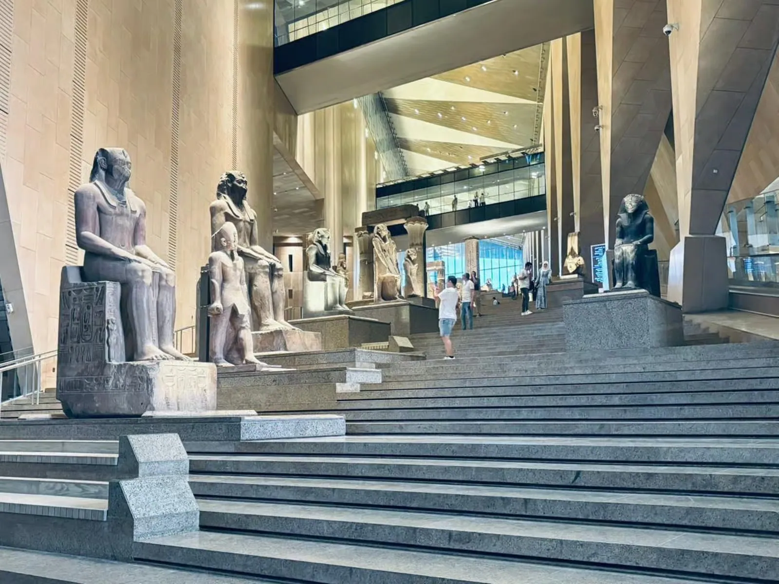 Seated statues on the Grand Staircase of the Grand Egyptian Museum