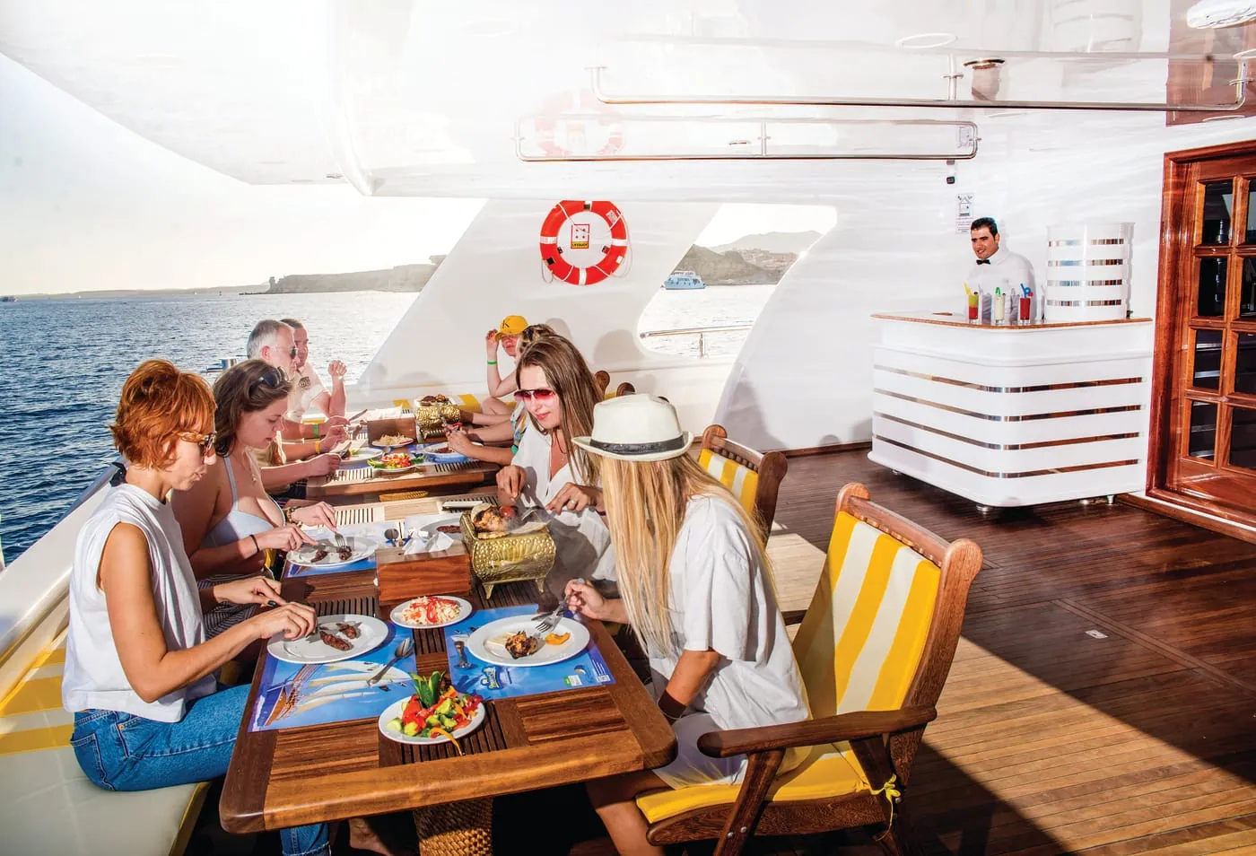 Guests at lunch on the shaded dining deck