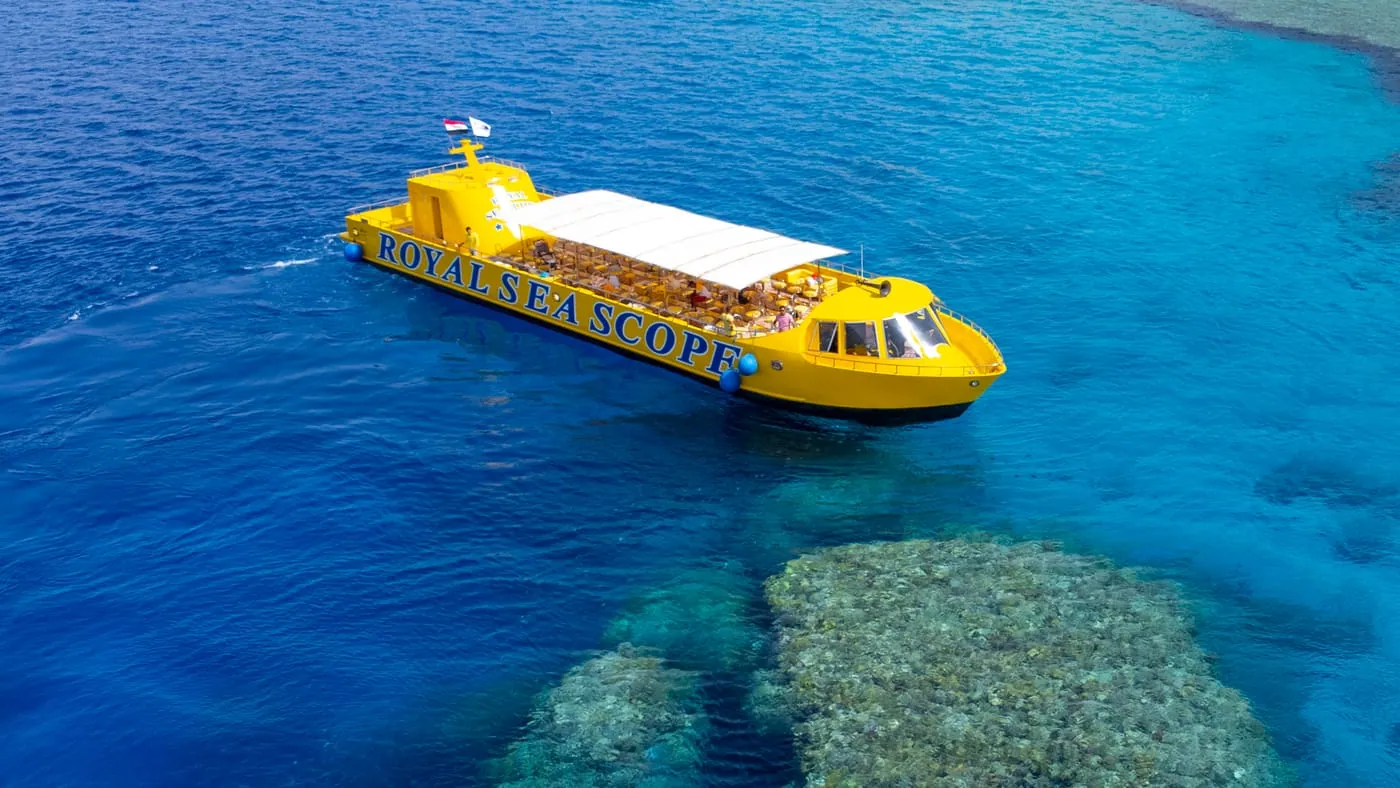 The yellow semi-submarine above a coral reef