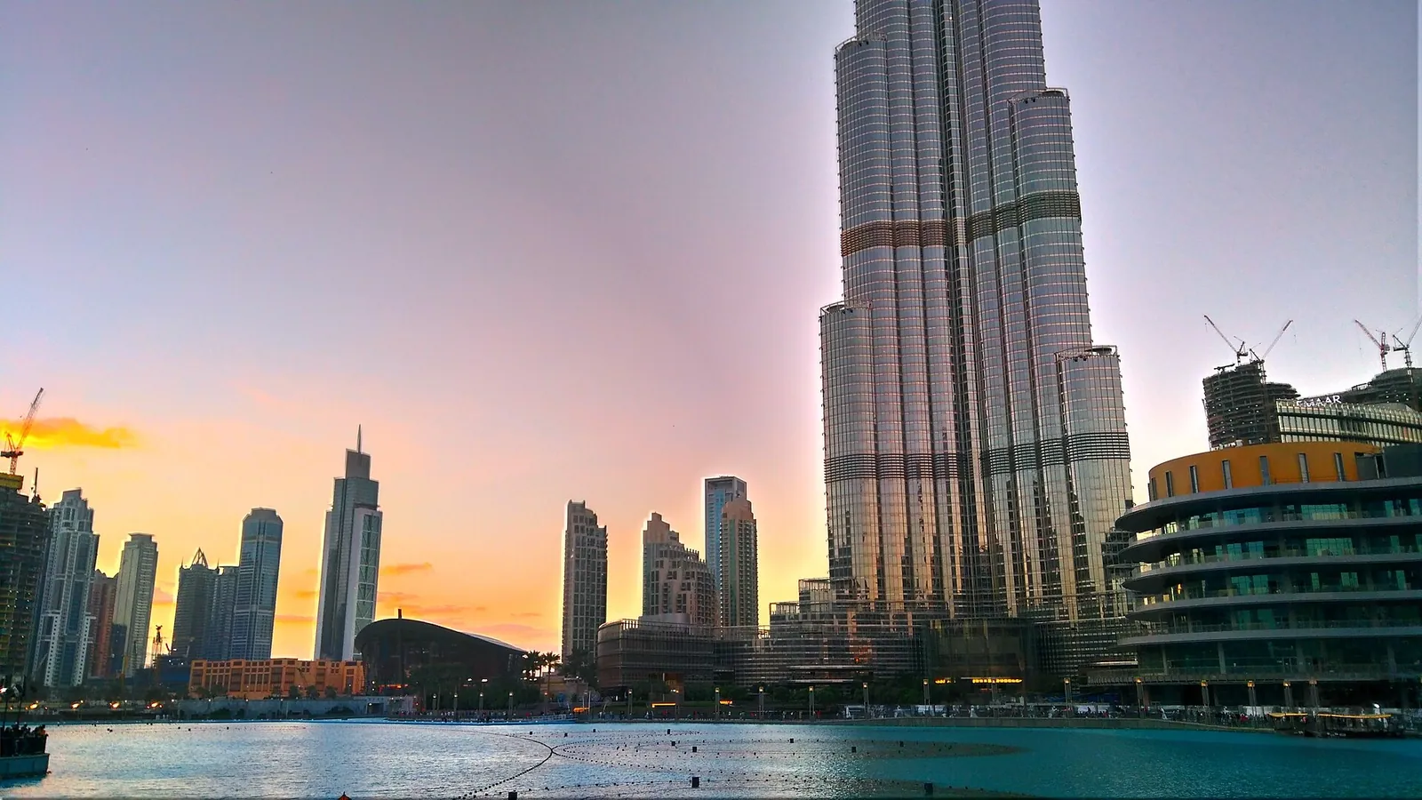 The Burj Khalifa above the Dubai Fountain lake at dusk