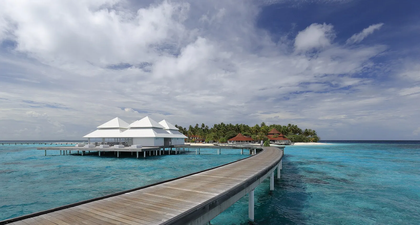 A wooden jetty leading to overwater villas in the Maldives