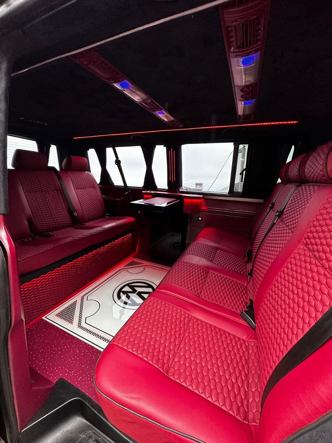 Red leather VIP van lounge interior for premium group transfers